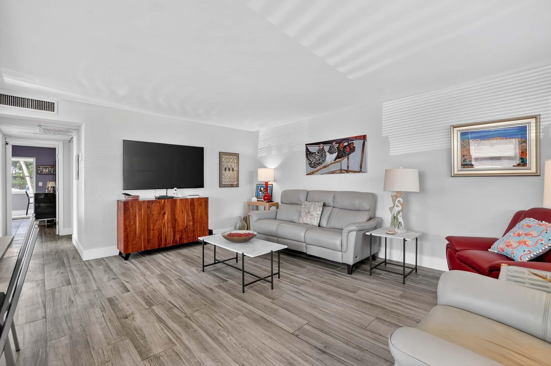 360 Flanders Drive, Unit H Delray Beach, FL 33484 - Photo 3 of 65 a living room with furniture and a flat screen tv
