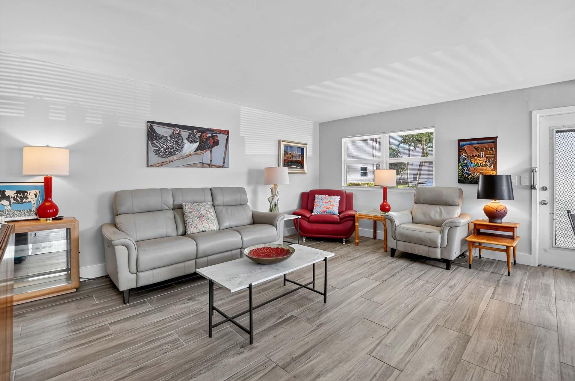 360 Flanders Drive, Unit H Delray Beach, FL 33484 - Photo 4 of 65 a living room with furniture and a wooden floor