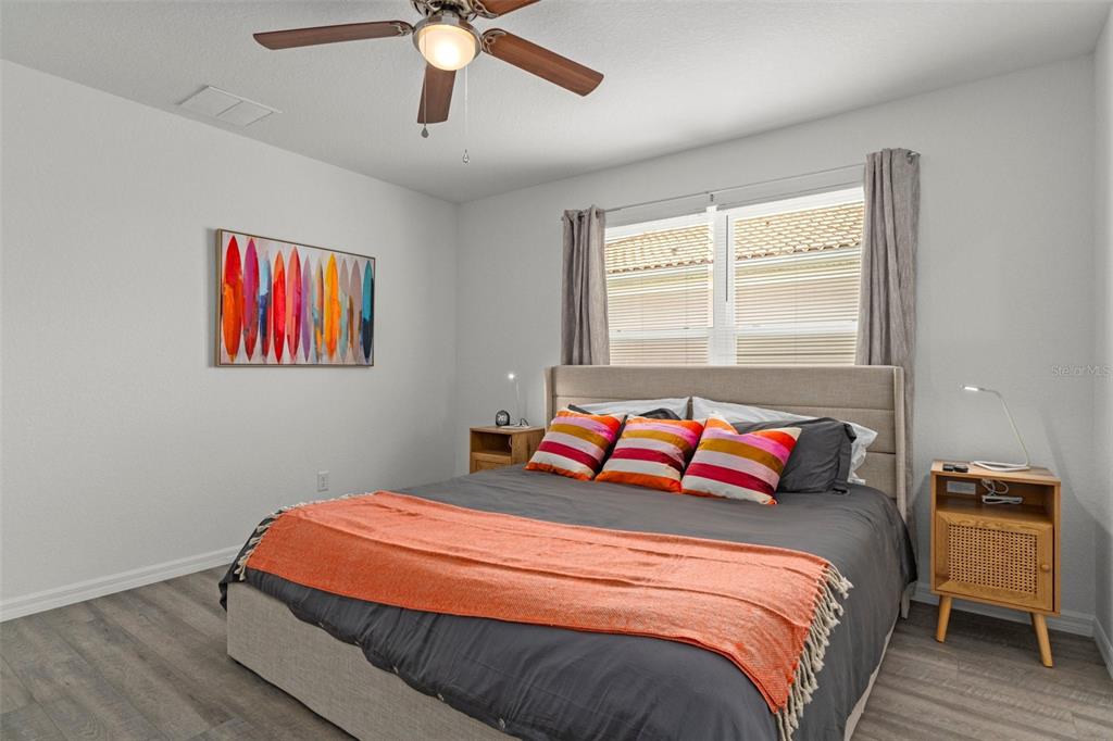 10234 West Middleburg Loop, Unit 152 Homosassa, FL 34448 - Photo 15 of 28 a bedroom with a bed and a chandelier