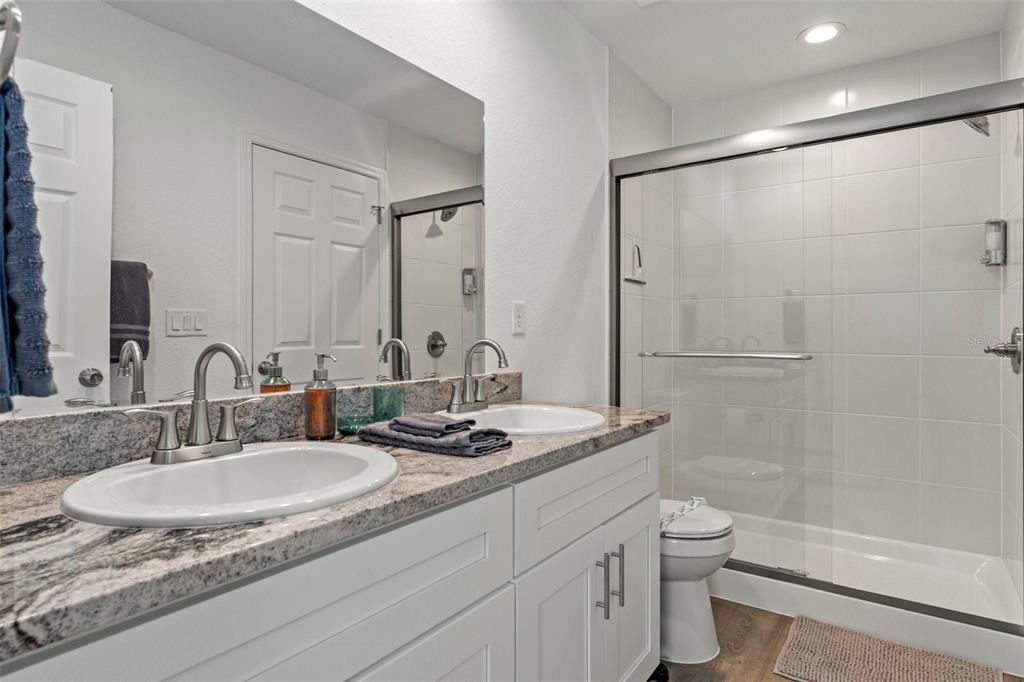 10234 West Middleburg Loop, Unit 152 Homosassa, FL 34448 - Photo 18 of 28 a bathroom with a granite countertop sink toilet and shower
