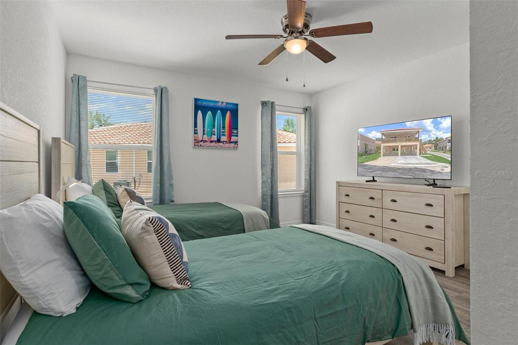 10234 West Middleburg Loop, Unit 152 Homosassa, FL 34448 - Photo 19 of 28 a bedroom with a bed and ceiling fan