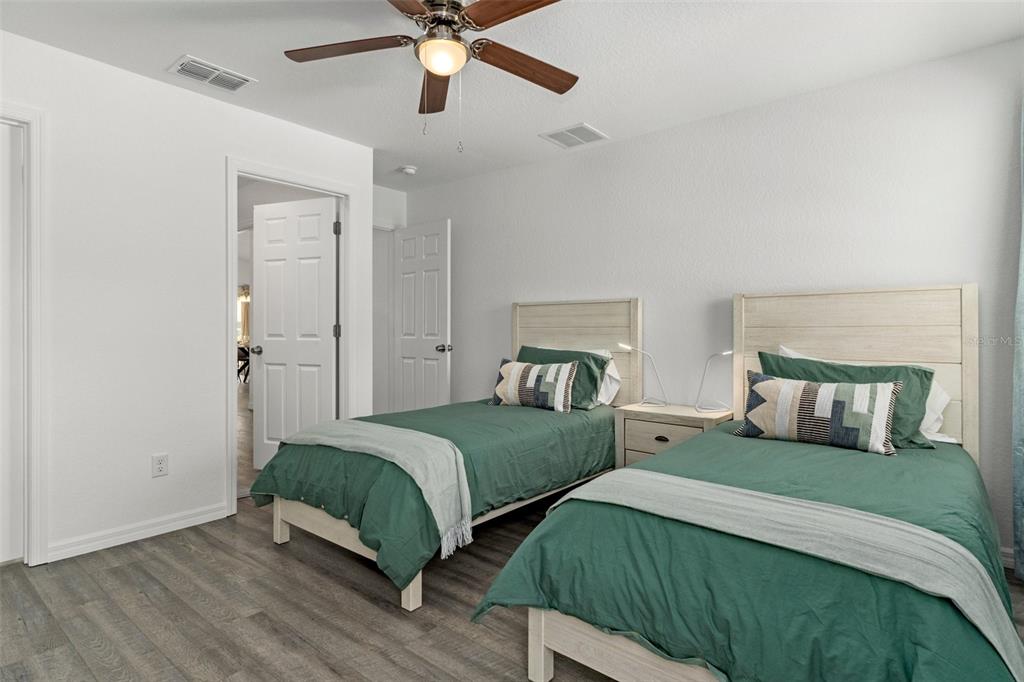 10234 West Middleburg Loop, Unit 152 Homosassa, FL 34448 - Photo 20 of 28 a bedroom with double bed and a chandelier