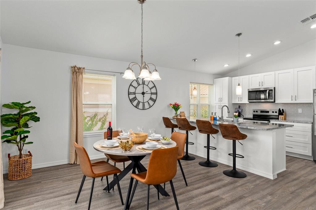 10234 West Middleburg Loop, Unit 152 Homosassa, FL 34448 - Photo 6 of 28 a view of a dining room with furniture a chandelier and wooden floor