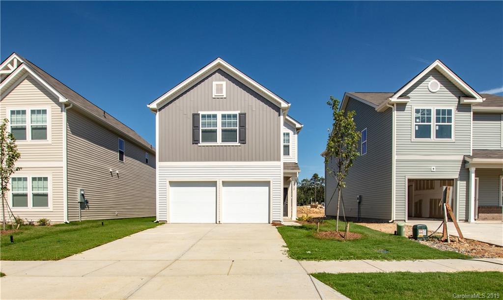 12532 Gotland Road, Unit 331 Midland, NC 28107 - Photo 1 of 26 a front view of a house with a yard and garage