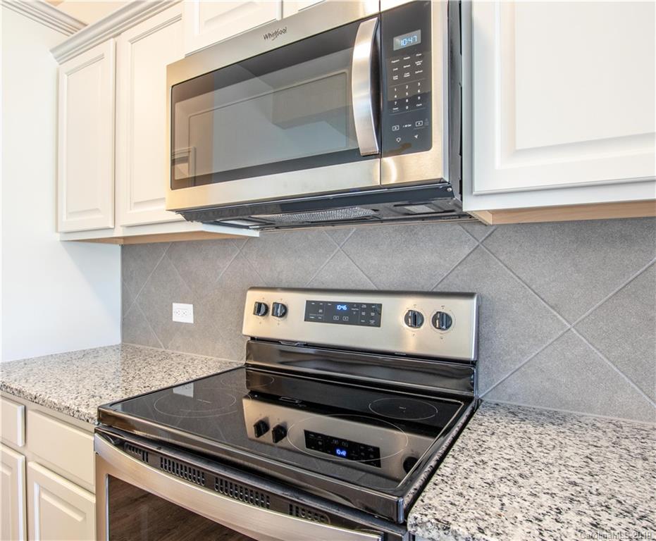 12532 Gotland Road, Unit 331 Midland, NC 28107 - Photo 12 of 26 a stove top oven sitting inside of a kitchen