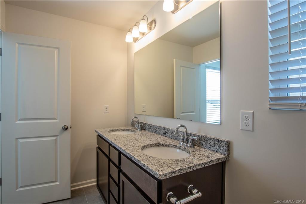 12532 Gotland Road, Unit 331 Midland, NC 28107 - Photo 20 of 26 a bathroom with a granite countertop sink and a mirror
