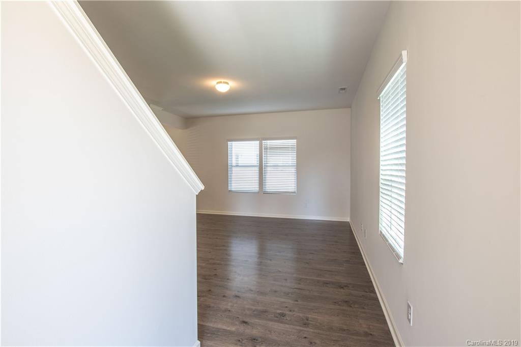 12532 Gotland Road, Unit 331 Midland, NC 28107 - Photo 3 of 26 wooden floor in an empty room with a window
