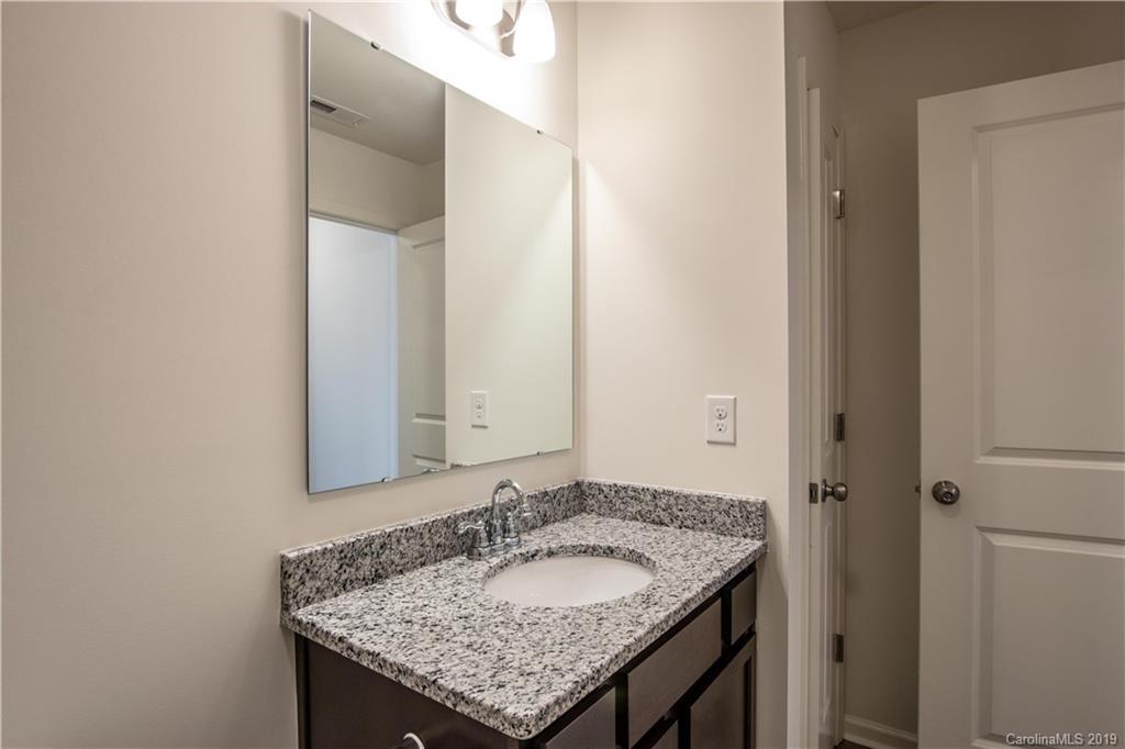 12532 Gotland Road, Unit 331 Midland, NC 28107 - Photo 24 of 26 a bathroom with a granite countertop sink and a mirror