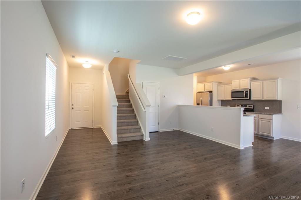 12532 Gotland Road, Unit 331 Midland, NC 28107 - Photo 5 of 26 a view of a kitchen with wooden floor and electronic appliances