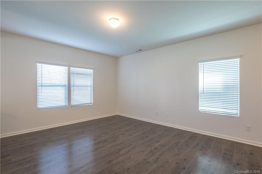 12532 Gotland Road, Unit 331 Midland, NC 28107 - Photo 6 of 26 an empty room with wooden floor and windows