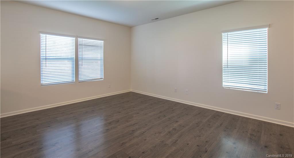 12532 Gotland Road, Unit 331 Midland, NC 28107 - Photo 7 of 26 an empty room with wooden closet and a window