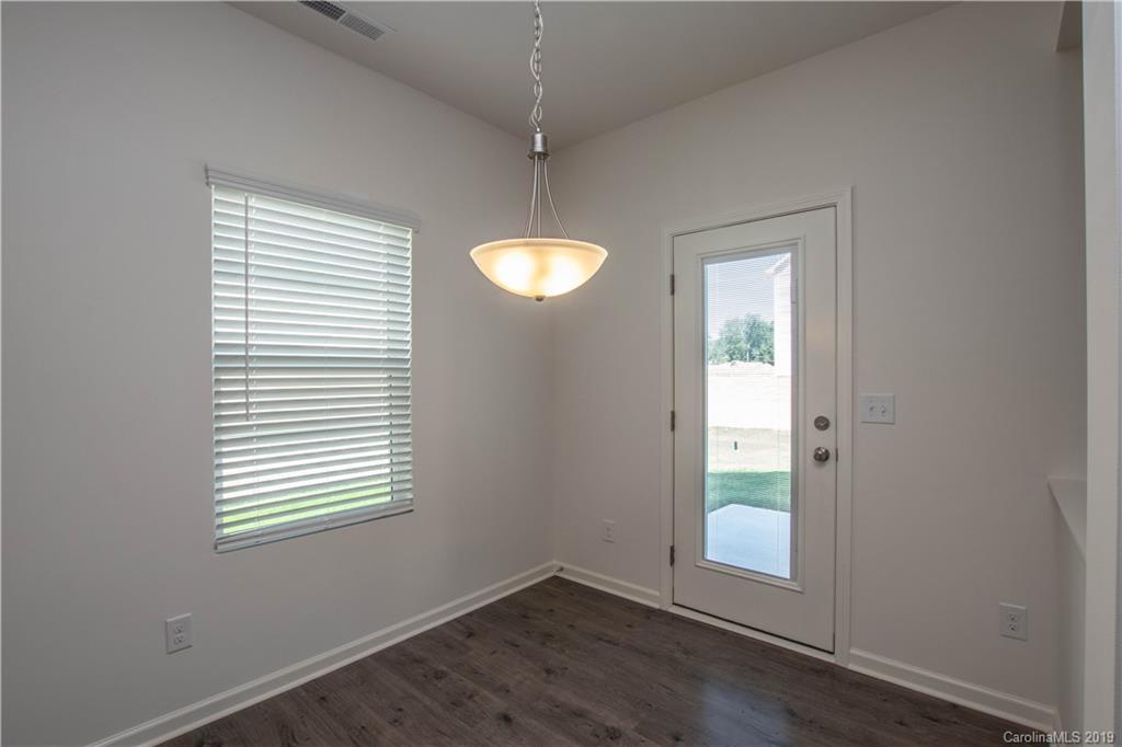 12532 Gotland Road, Unit 331 Midland, NC 28107 - Photo 9 of 26 an empty room with wooden floor and windows