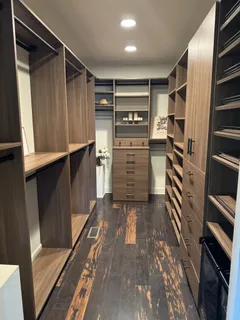 a view of walk in closet with clothes and shoes