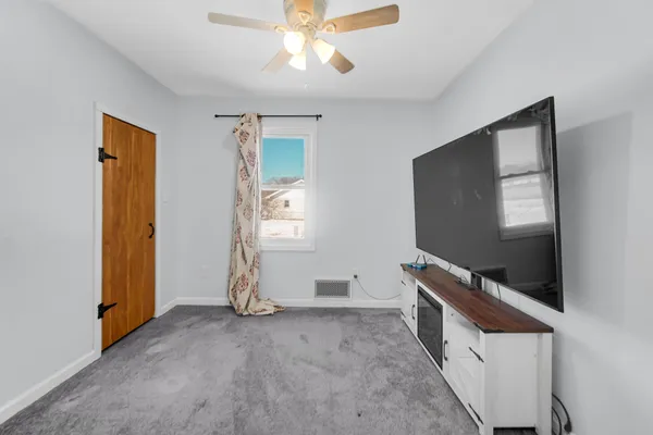 a view of room with window and flat screen tv