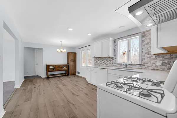 a kitchen with stainless steel appliances a white stove top oven sink and cabinets