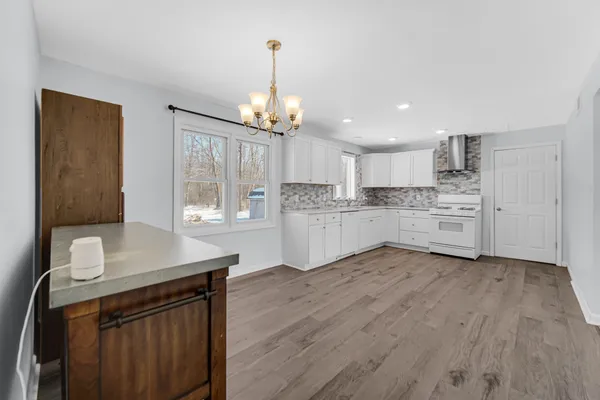 a kitchen with stainless steel appliances granite countertop a stove sink and cabinets