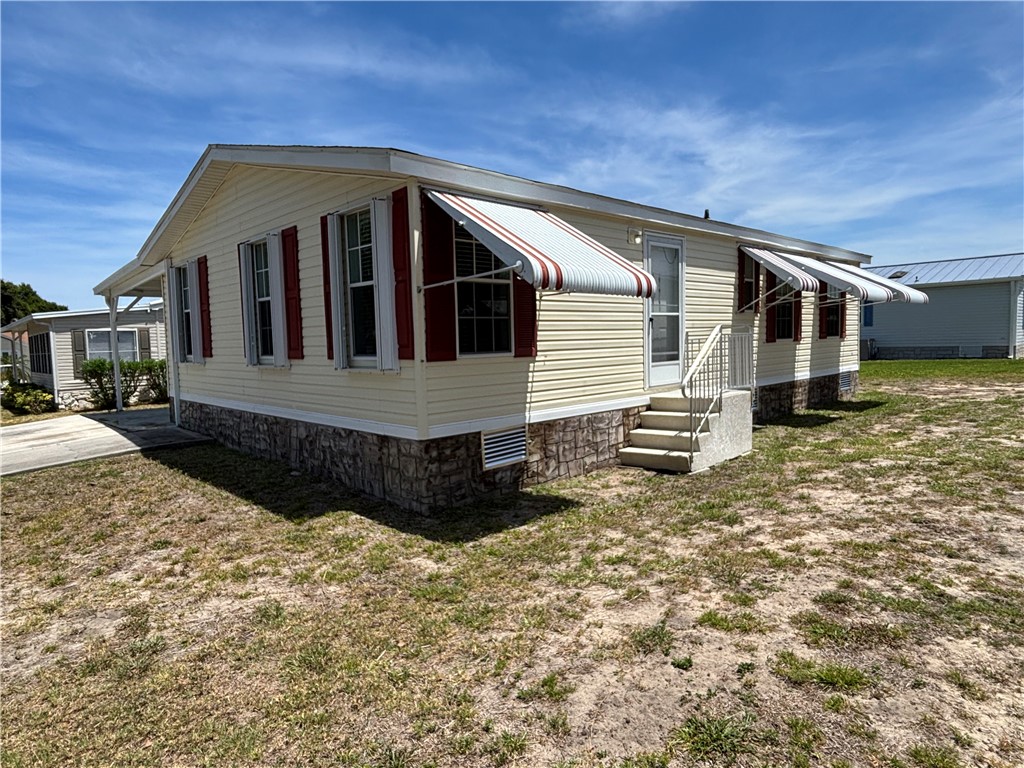 6171 98th Road Sebastian, FL 32958 - Photo 2 of 14 a front view of a house with a yard