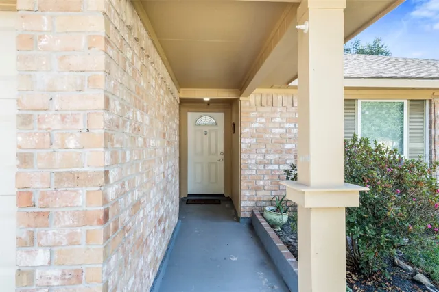 a view of a brick house with a windows and wooden door