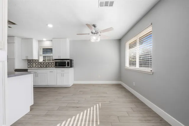 a kitchen with stainless steel appliances kitchen island granite countertop a stove a sink and a refrigerator