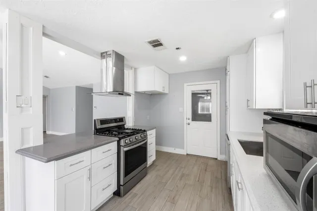 a kitchen with a stove a sink and a refrigerator
