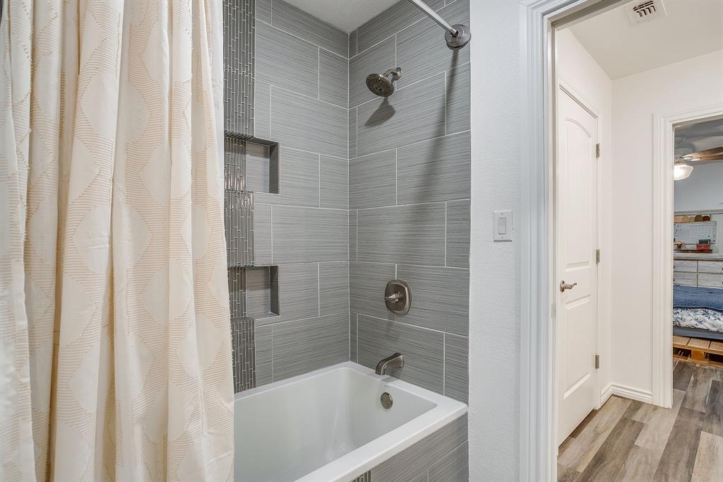 733 Fm 2652 Graham, TX 76450 - Photo 20 of 40 a bathroom with a bathtub and shower
