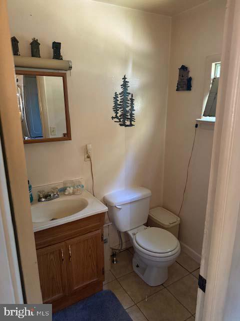 5976 Genoa Avenue Vineland, NJ 08360 - Photo 5 of 6 a bathroom with a toilet a sink and mirror