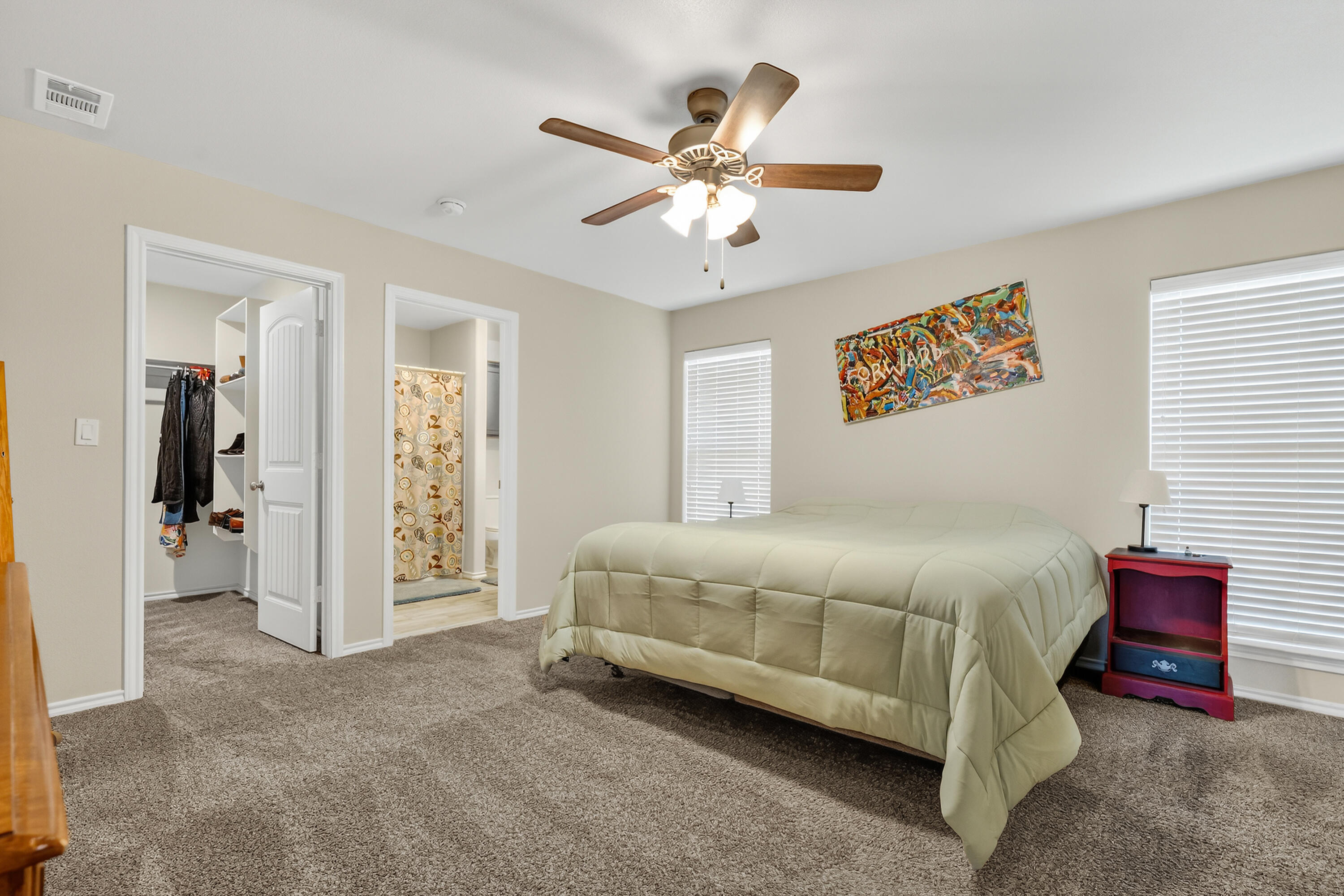 7402 105th Street Lubbock, TX 79424 - Photo 11 of 22 a bedroom with a bed and a chandelier