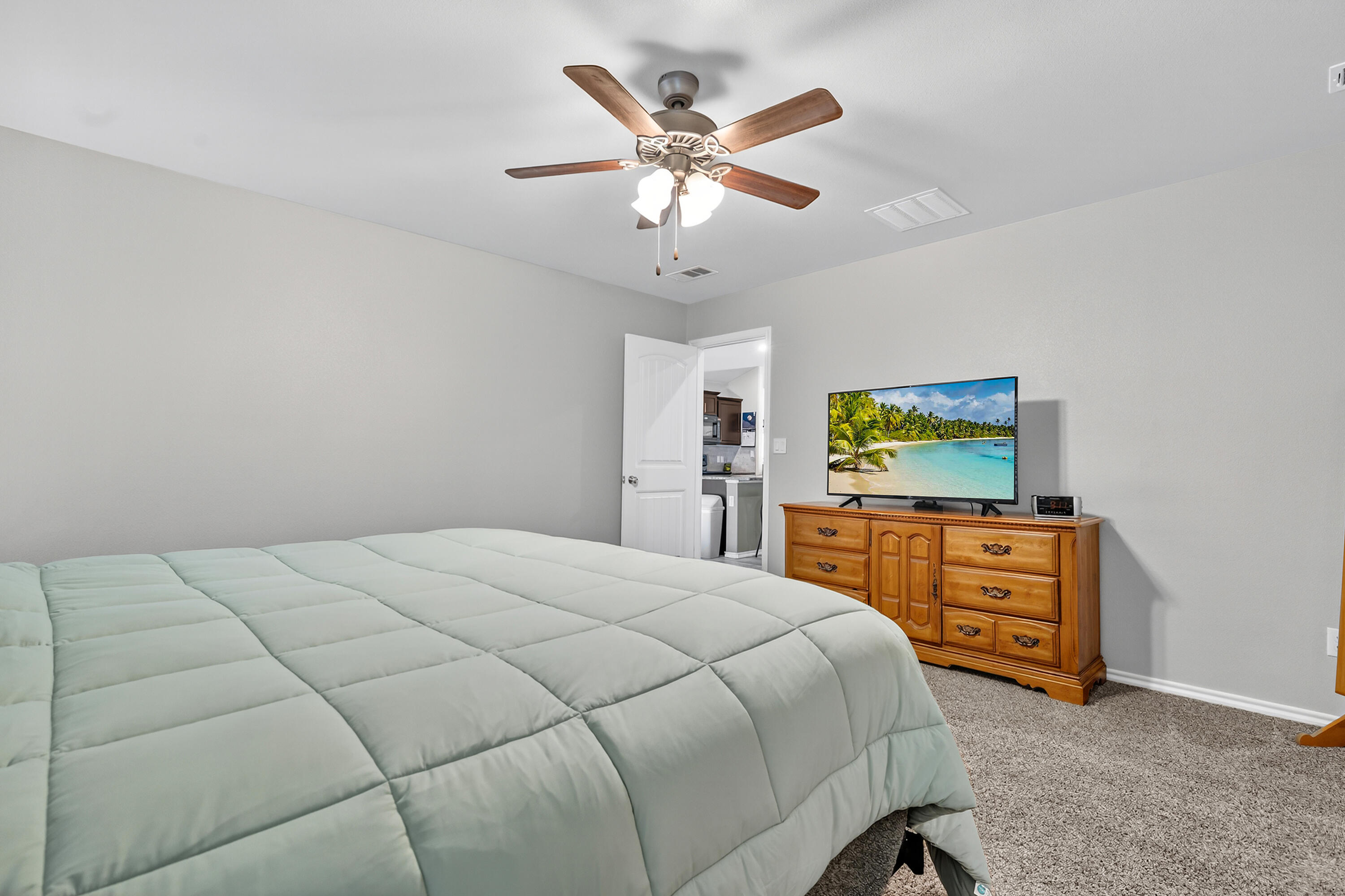 7402 105th Street Lubbock, TX 79424 - Photo 12 of 22 a bedroom with a bed and a dresser