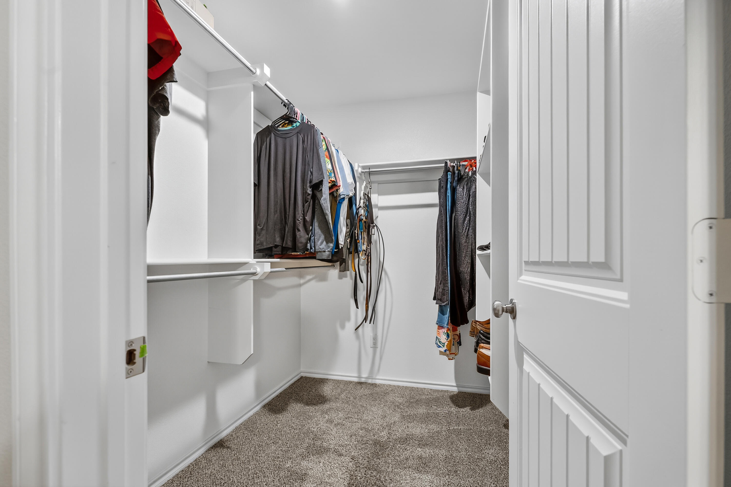 7402 105th Street Lubbock, TX 79424 - Photo 14 of 22 a view of walk in closet with clothes