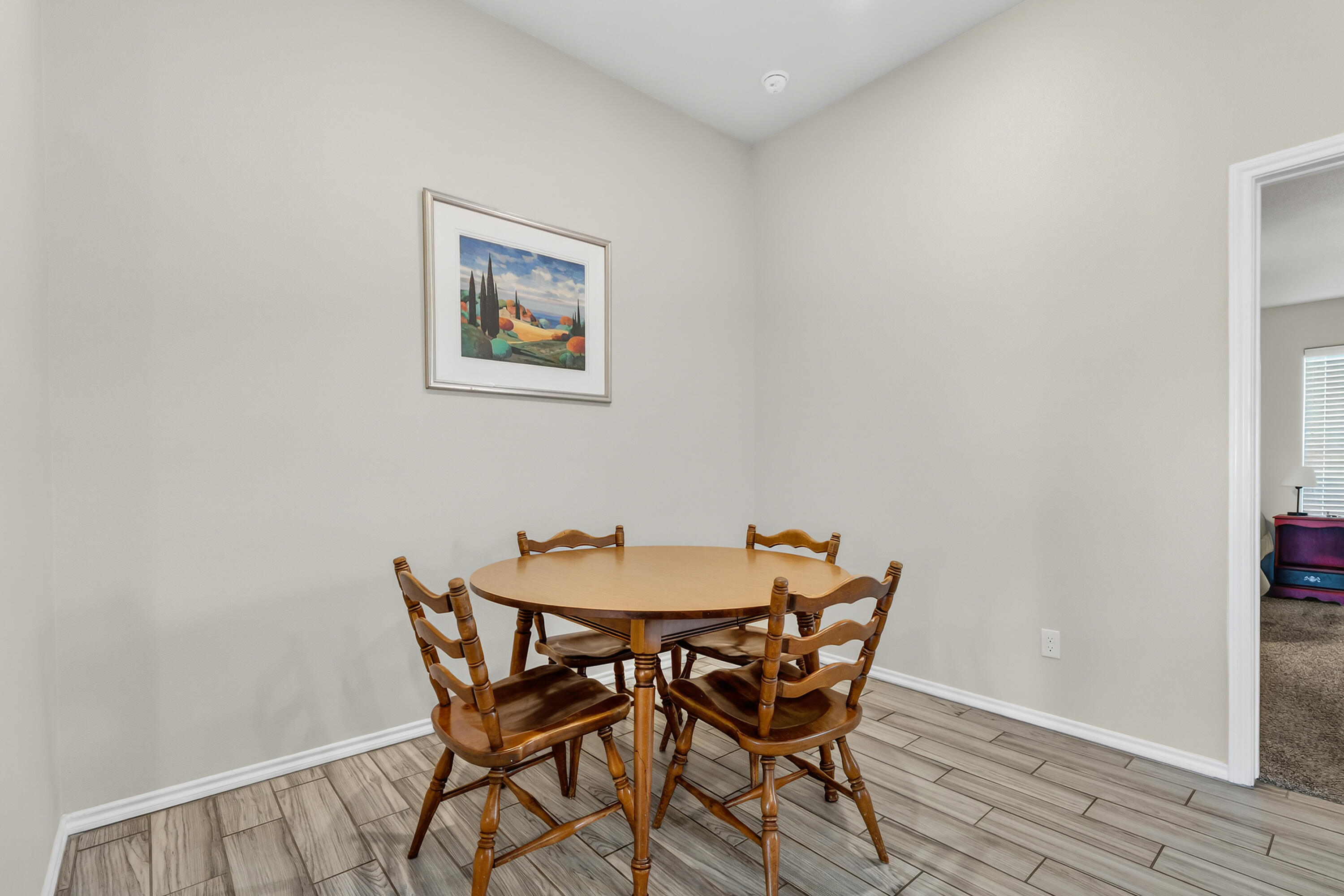 7402 105th Street Lubbock, TX 79424 - Photo 9 of 22 a view of a dining room with furniture and wooden floor