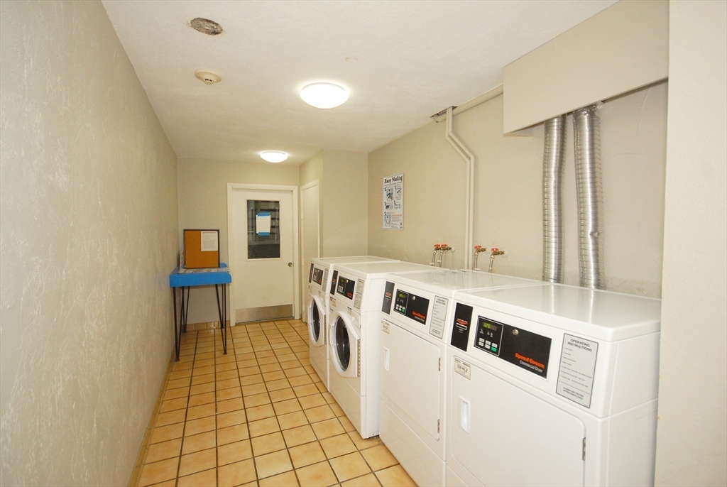 188 Swanson Road, Unit 330 Boxborough, MA 01719 - Photo 14 of 18 a kitchen with stainless steel appliances a stove a sink and a refrigerator