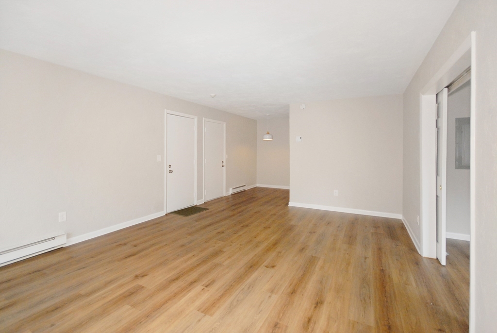 188 Swanson Road, Unit 330 Boxborough, MA 01719 - Photo 2 of 18 a view of empty room with wooden floor and entryway