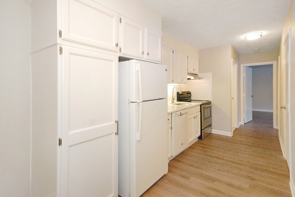 188 Swanson Road, Unit 330 Boxborough, MA 01719 - Photo 7 of 18 a kitchen with a refrigerator a stove top oven and cabinets