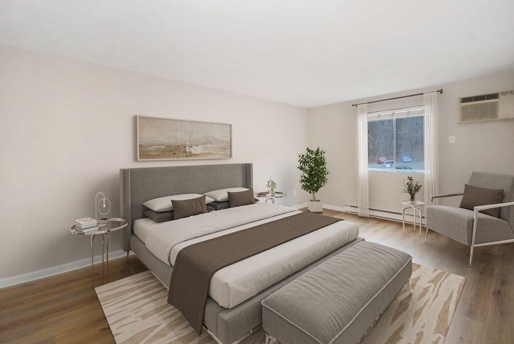188 Swanson Road, Unit 330 Boxborough, MA 01719 - Photo 8 of 18 a bedroom with a bed and wooden floor