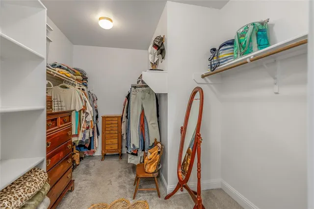 a bathroom with a white tub a sink and a window