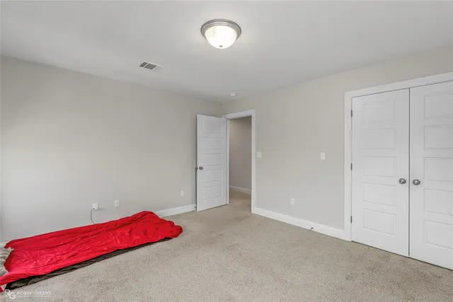 an empty room with windows and closet