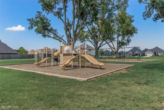 a view of outdoor space with green field and trees