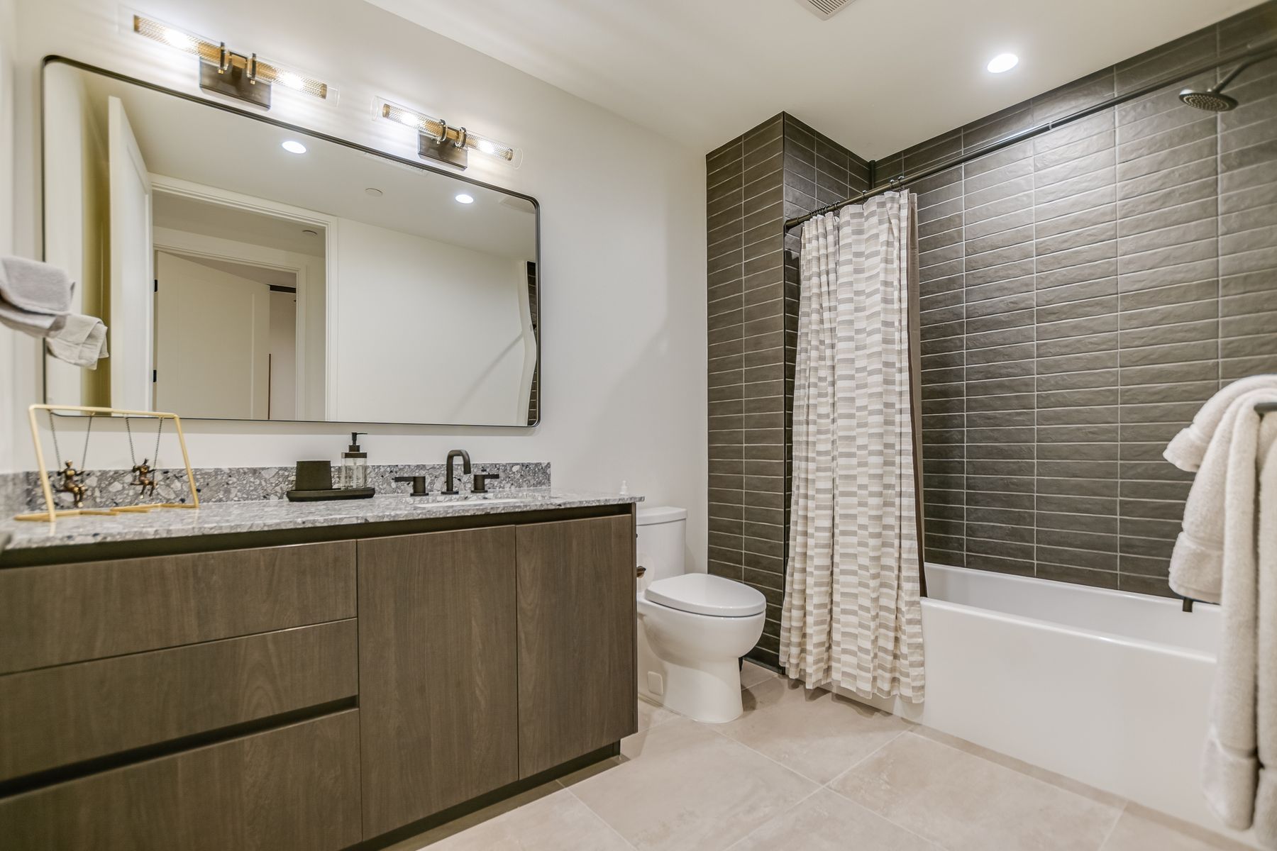 84 East Avenue, Unit 3909 Austin, TX 78701 - Photo 9 of 26 Full bath featuring vanity, recessed lighting, shower / bath combo with shower curtain, and light tile patterned floors