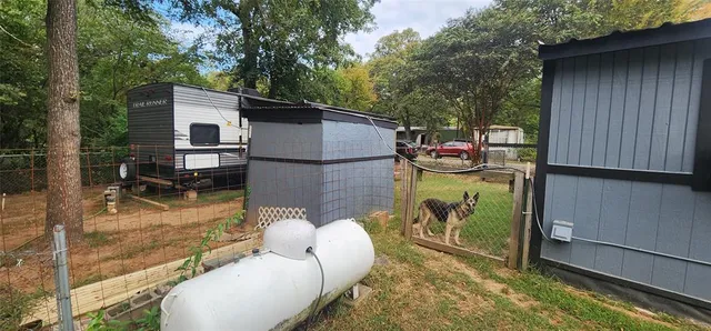 a view of a house with backyard water fountain and sitting area