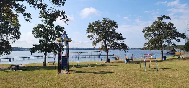a view of backyard with barbeque grill and potted plants