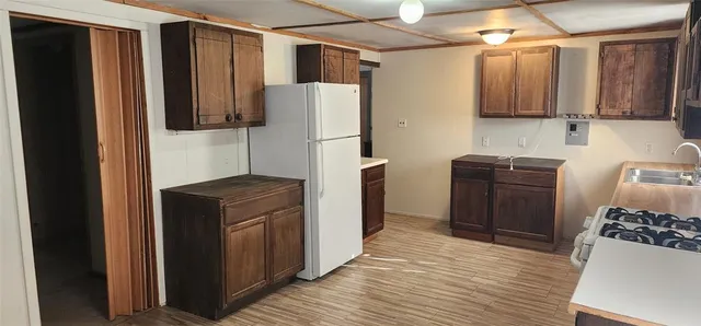 a kitchen with stainless steel appliances granite countertop a refrigerator and a stove
