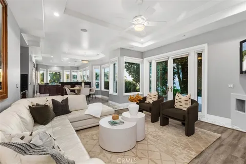 a living room with furniture and floor to ceiling windows