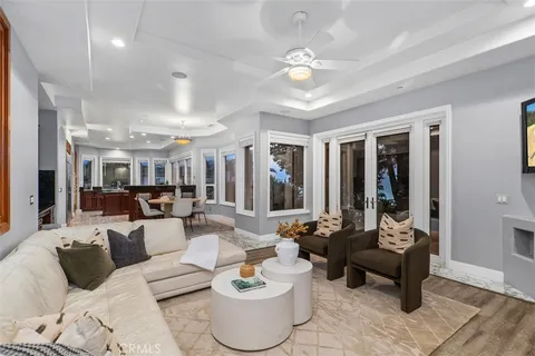 a living room with furniture large window and a fireplace