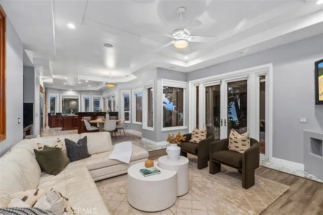 a living room with furniture large window and a fireplace
