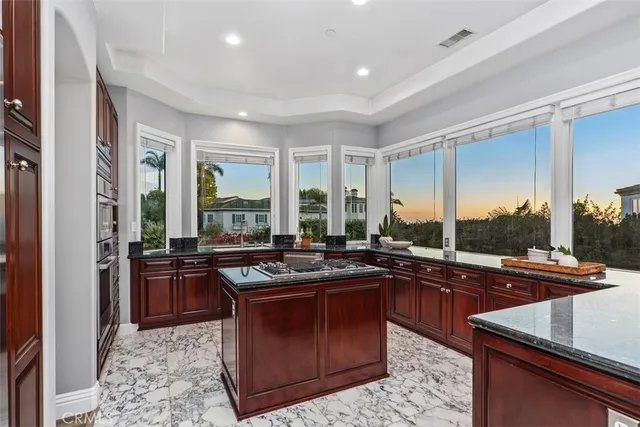 a kitchen with a stove a sink a dining table and chairs