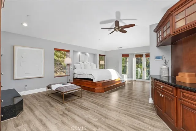 a spacious bedroom with a bed and a dresser