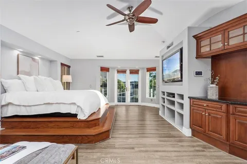 a spacious bathroom with a tub a sink double vanity and a mirror