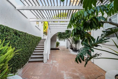 a view of a house with sitting area and garden