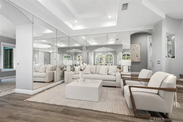 a living room with furniture and a large mirror
