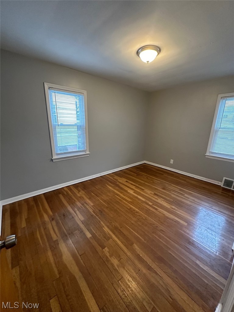 4994 North Barton Road Cleveland, OH 44124 - Photo 13 of 28 Unfurnished room featuring a wealth of natural light and dark hardwood / wood-style flooring